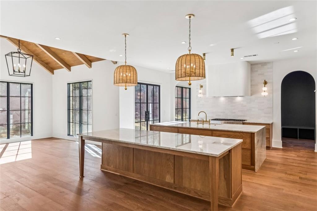 200 River Valley Court Northwest Atlanta, GA 30328 - Photo 9 of 25 a kitchen with stainless steel appliances granite countertop a sink a oven and a wooden floors