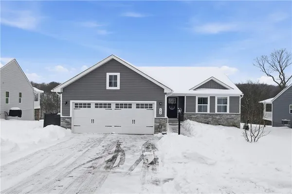 a view of a house with a yard covered in snow