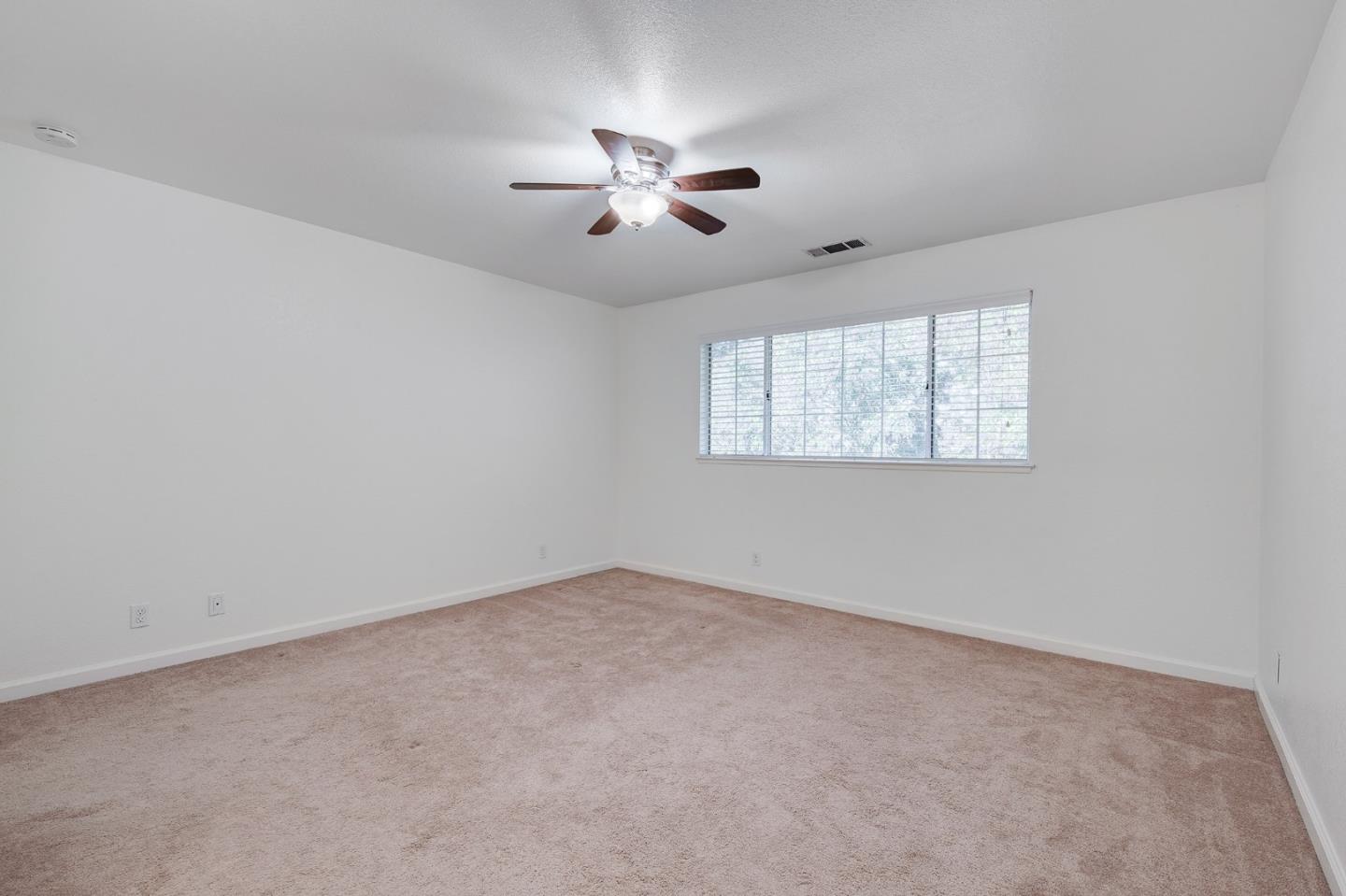 1013 Woodside Road Redwood City, CA 94061 - Photo 14 of 20 an empty room with windows and fan