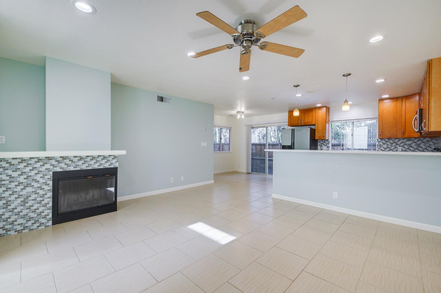 1013 Woodside Road Redwood City, CA 94061 - Photo 3 of 20 an open kitchen view with fireplace and a ceiling fan