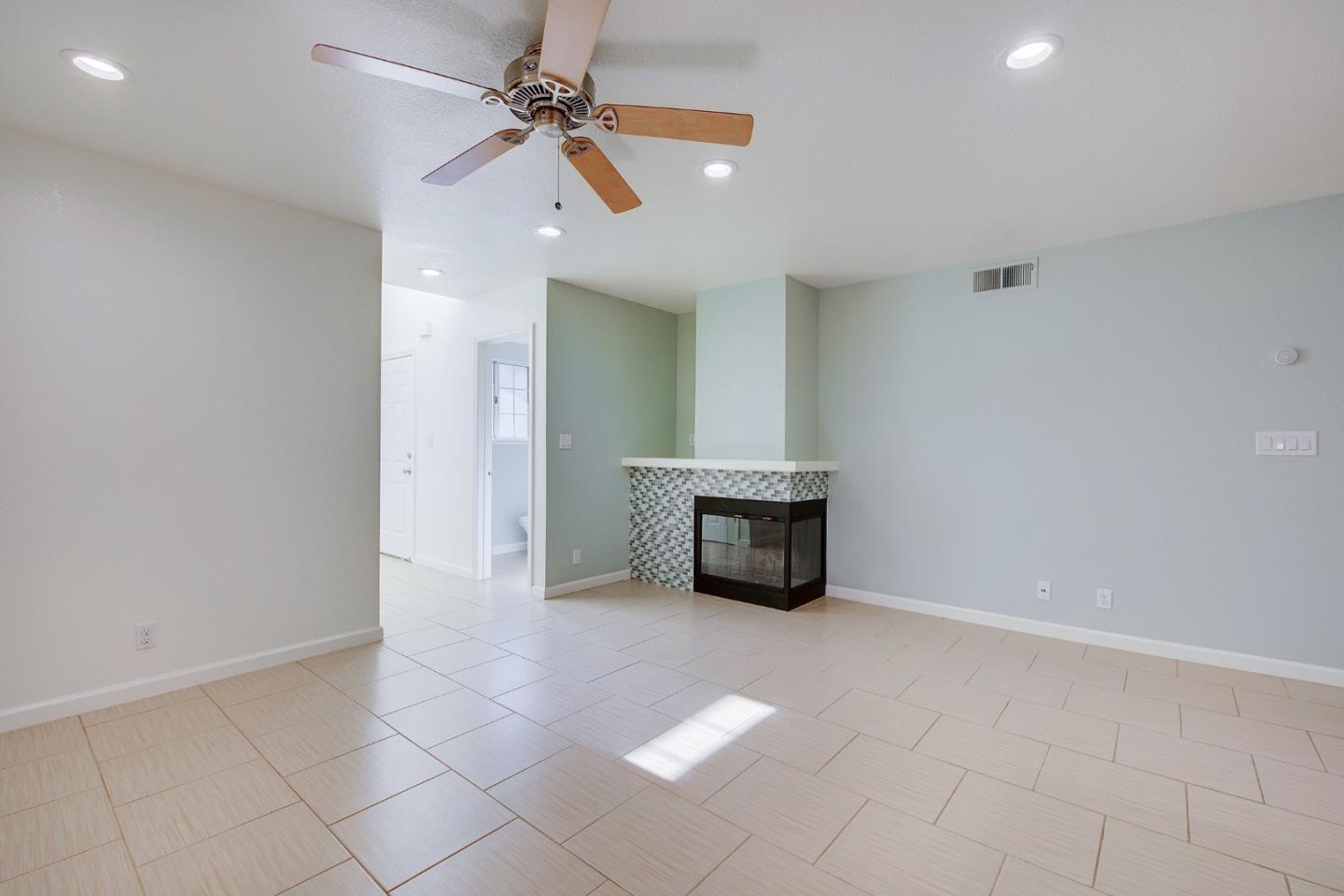 1013 Woodside Road Redwood City, CA 94061 - Photo 4 of 20 an empty room with windows and fan