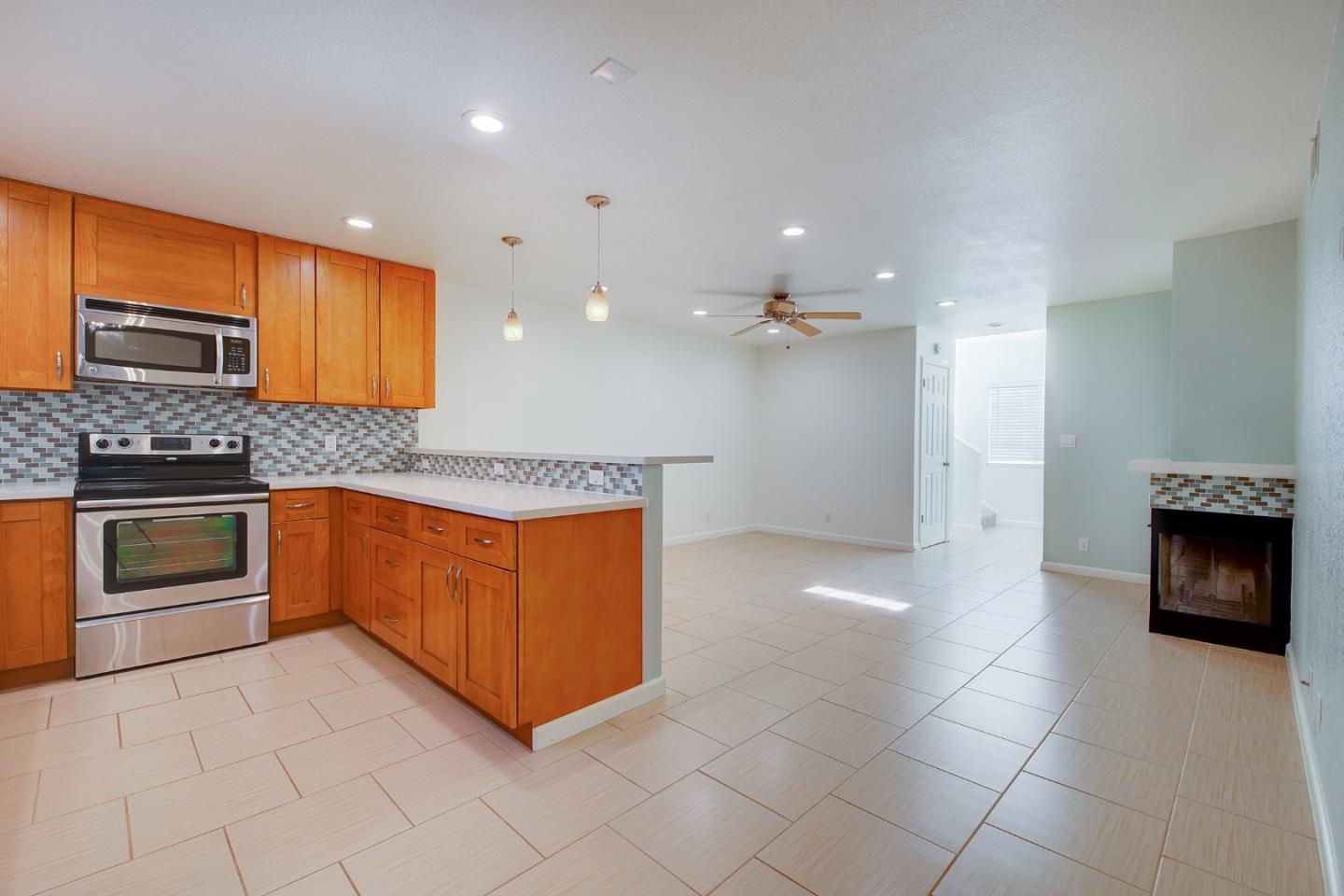 1013 Woodside Road Redwood City, CA 94061 - Photo 5 of 20 a kitchen with stainless steel appliances granite countertop a stove a sink and a refrigerator