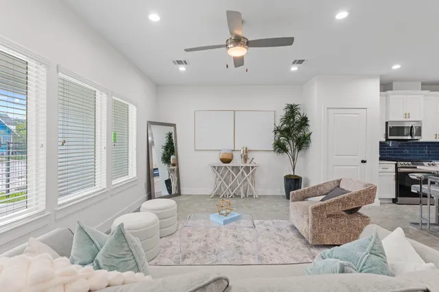 a living room with furniture and a large window