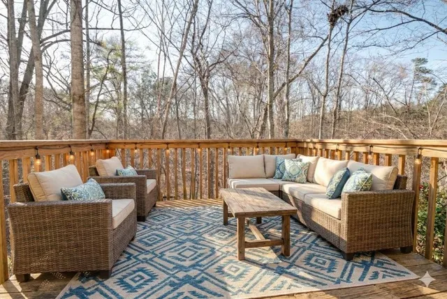 a roof deck with couches and wooden floor