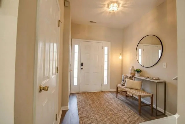 a living room with furniture and a mirror