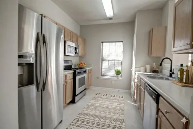 a kitchen with a refrigerator and a sink