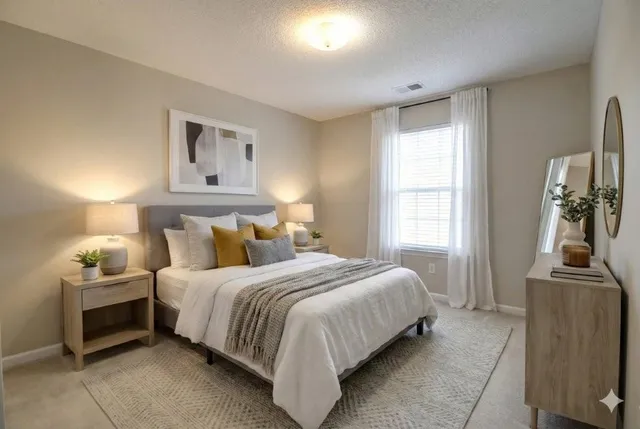 a bedroom with a bed and glass windows