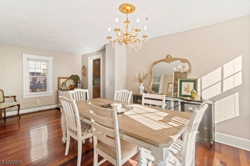 22 Mott Place Rockaway, NJ 07866 - Photo 13 of 42 a view of a dining room with furniture a chandelier and wooden floor