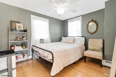 a bedroom with bed and a window