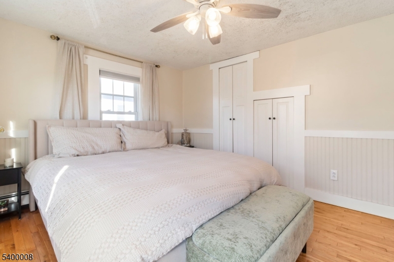 22 Mott Place Rockaway, NJ 07866 - Photo 26 of 42 a bedroom with a large bed and a chandelier