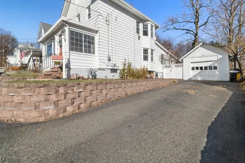 a front view of a house with a road