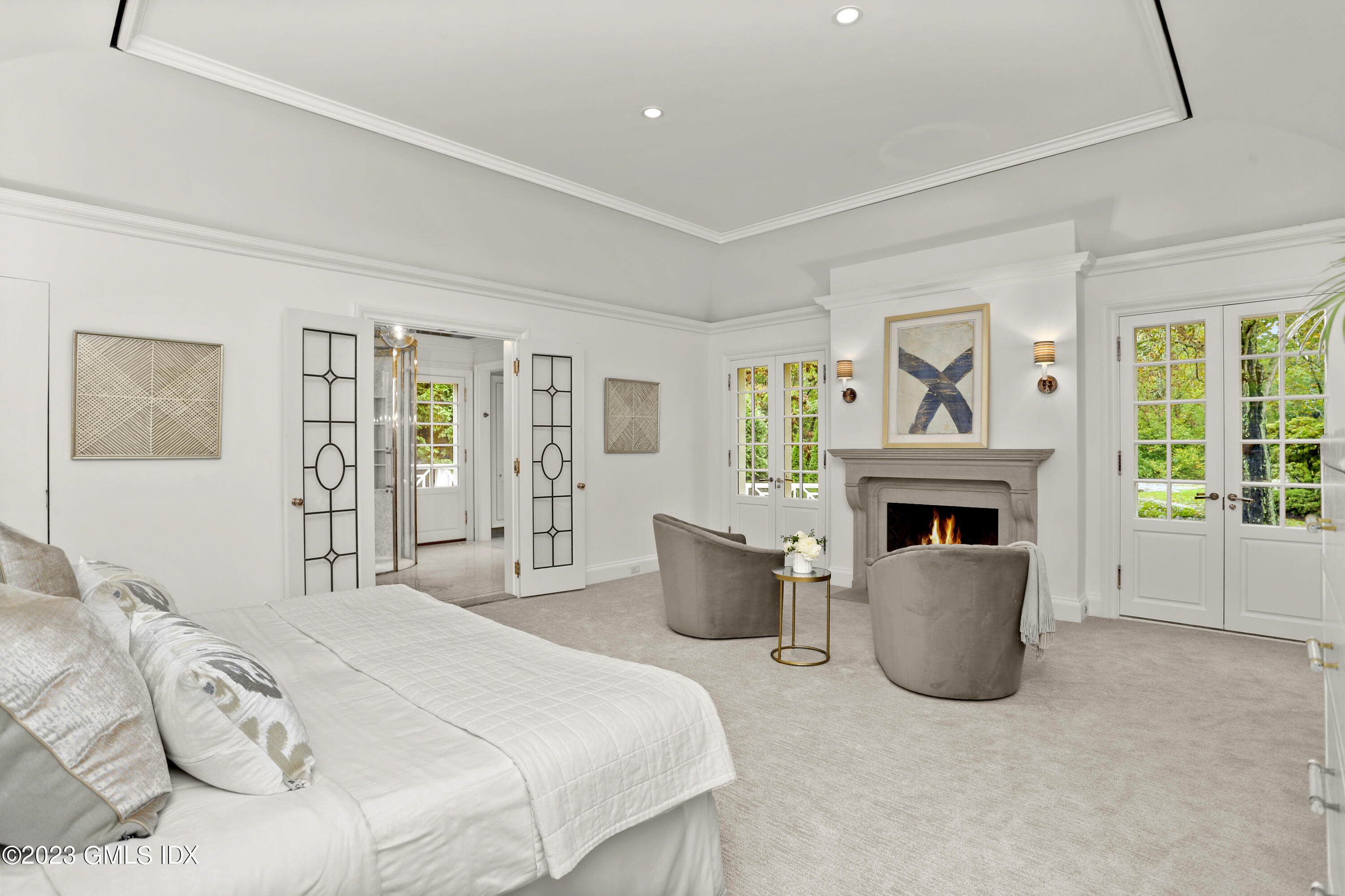 26 Memory Lane Greenwich, CT 06831 - Photo 14 of 43 a spacious bedroom with a balcony a bed and a fireplace