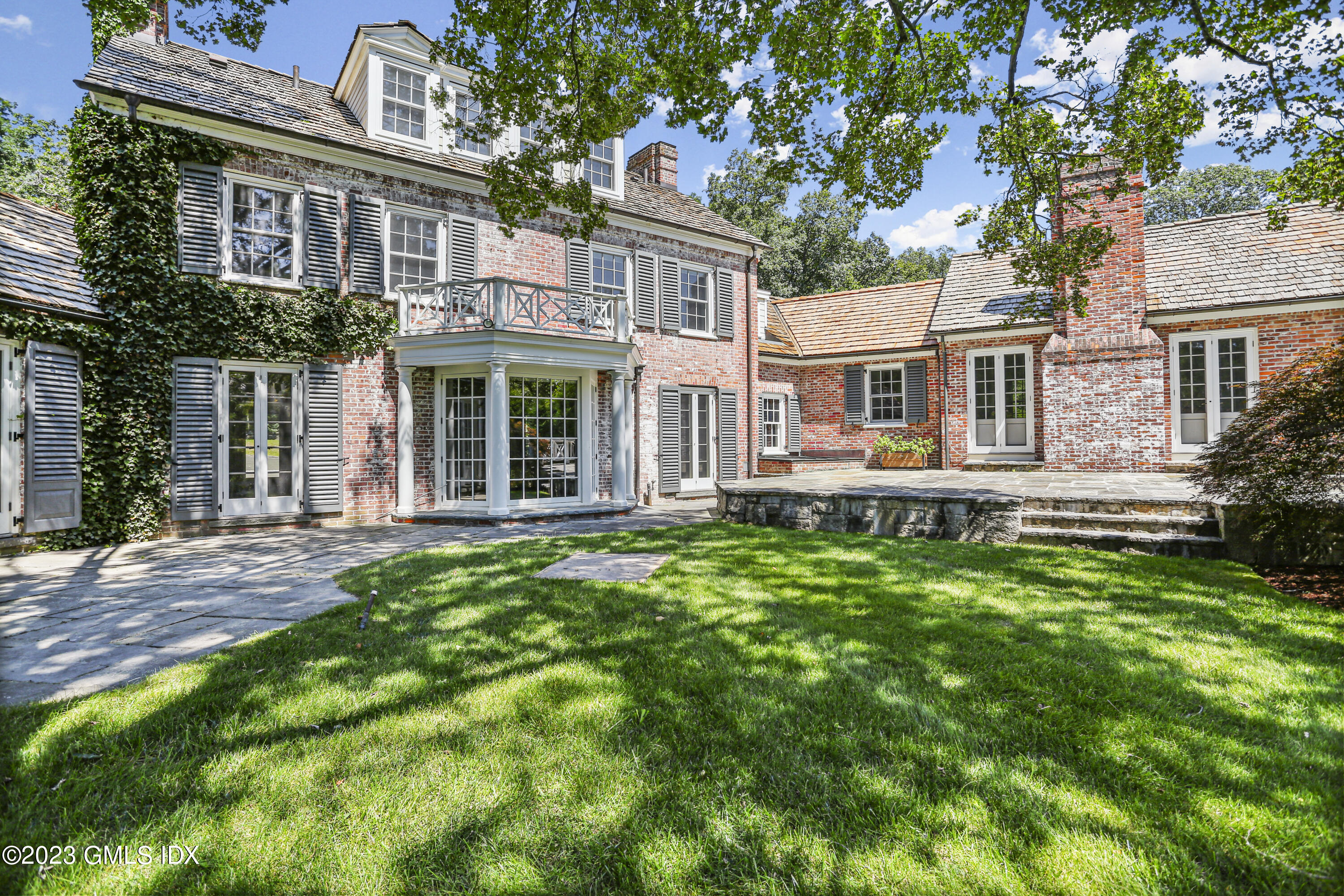 26 Memory Lane Greenwich, CT 06831 - Photo 30 of 43 front view of a house with a yard