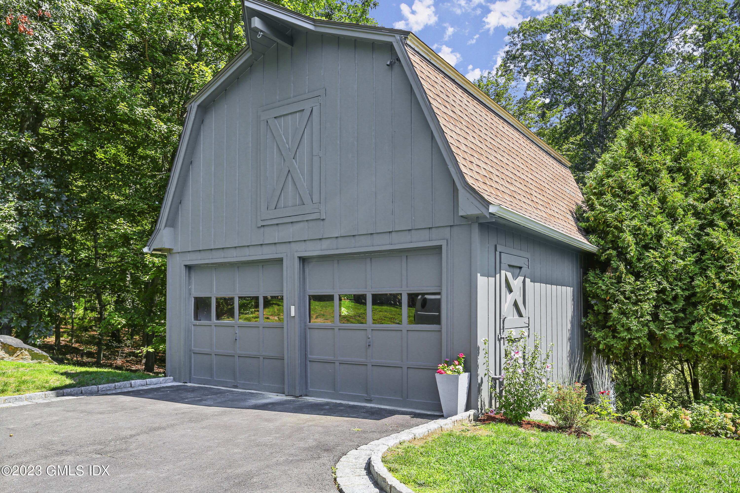 26 Memory Lane Greenwich, CT 06831 - Photo 34 of 43 a front view of a house with garden