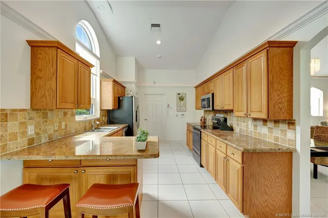 a kitchen with stainless steel appliances granite countertop a sink and cabinets