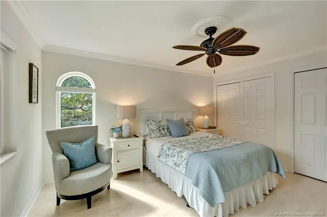 a bedroom with a large bed and a window