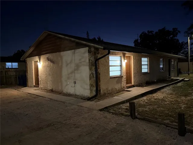 a view of backyard with hardwood floor and window