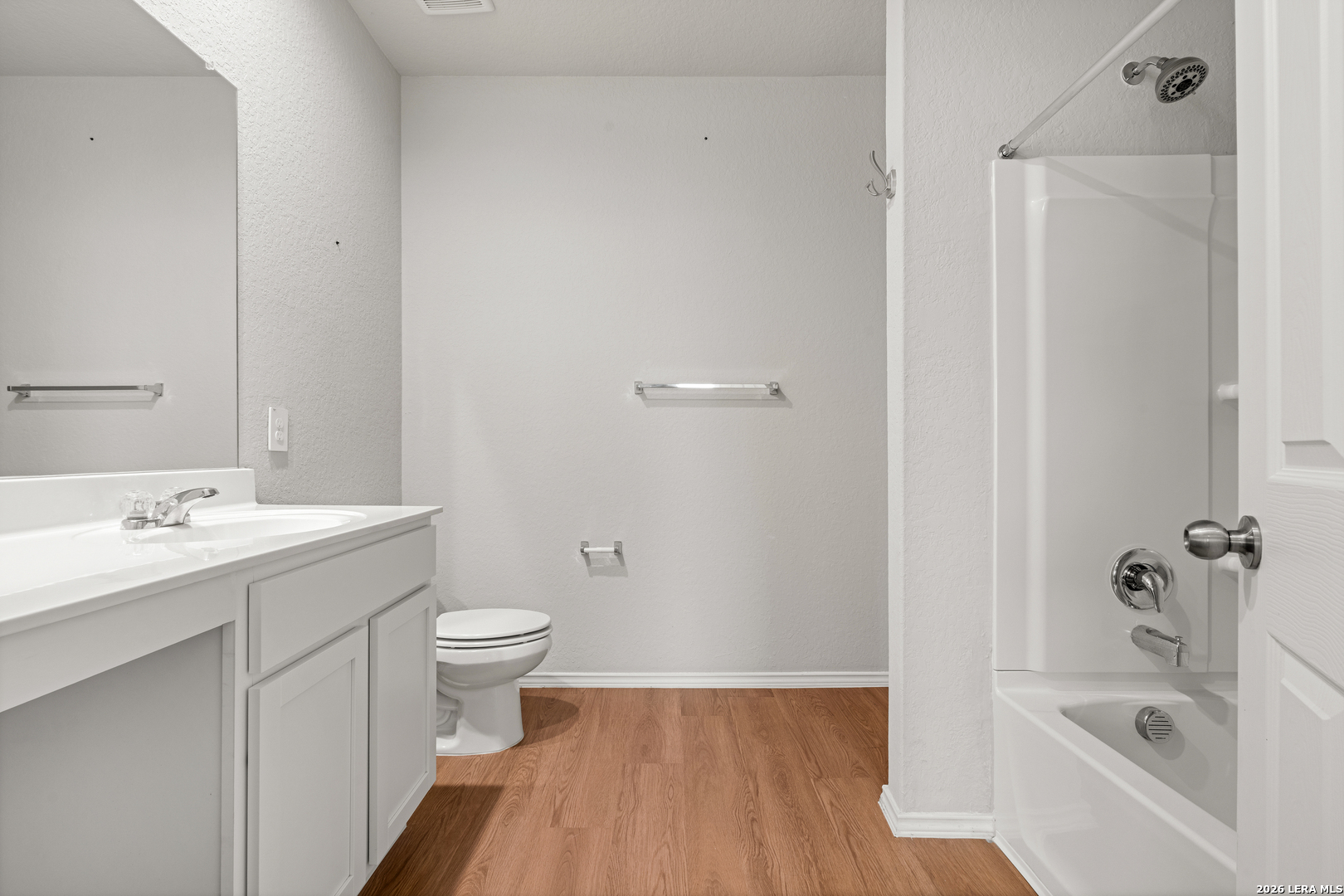 14606 Hackamore Way Elmendorf, TX 78112 - Photo 11 of 18 a bathroom with a sink a toilet and shower