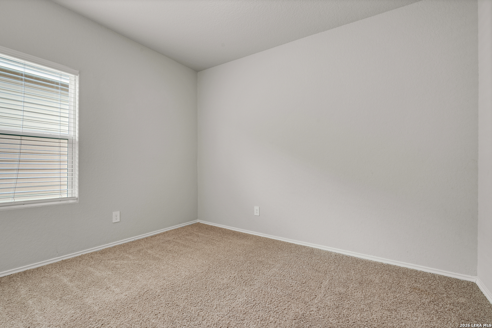 14606 Hackamore Way Elmendorf, TX 78112 - Photo 12 of 18 an empty room with a window