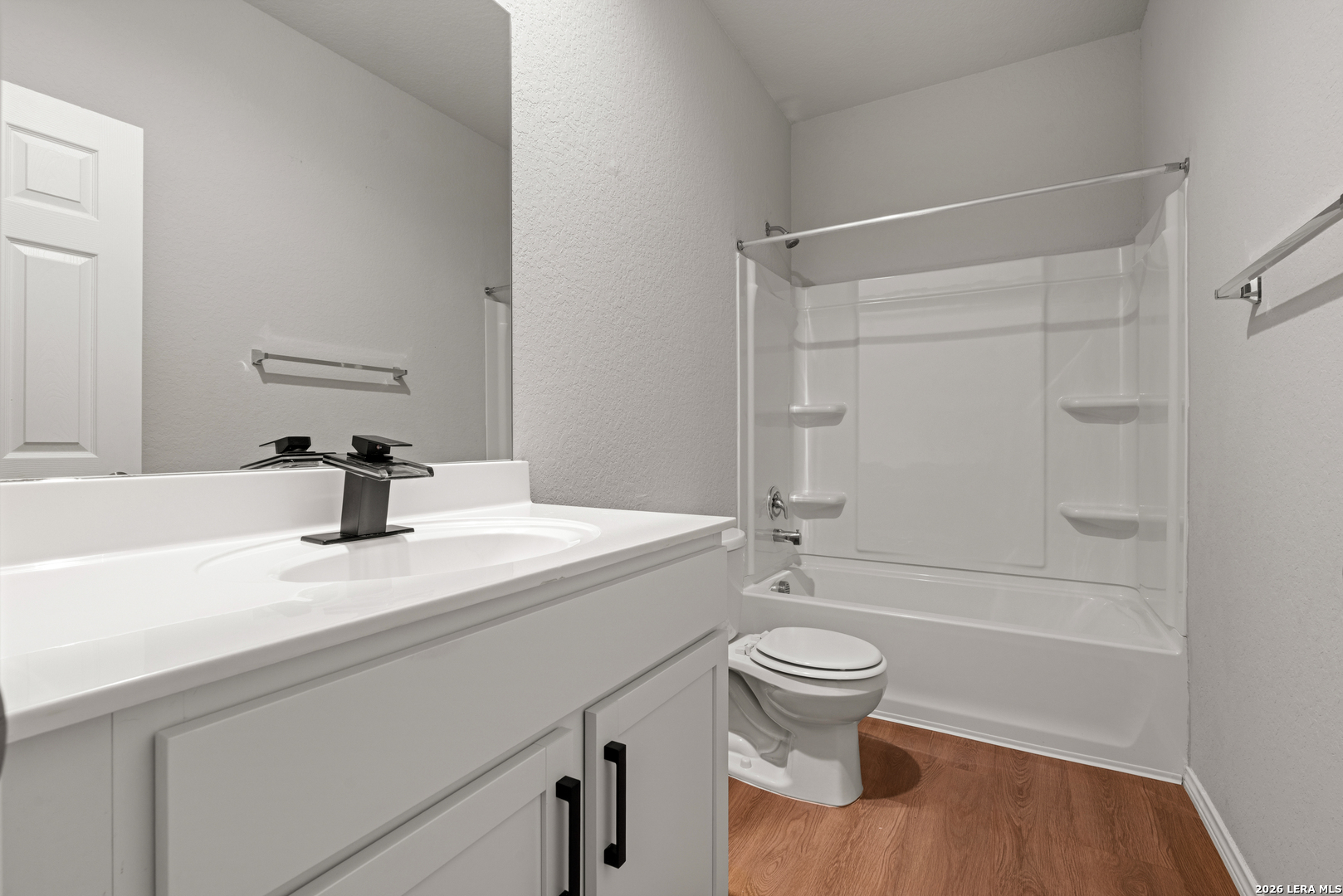 14606 Hackamore Way Elmendorf, TX 78112 - Photo 14 of 18 a bathroom with a sink a toilet and shower