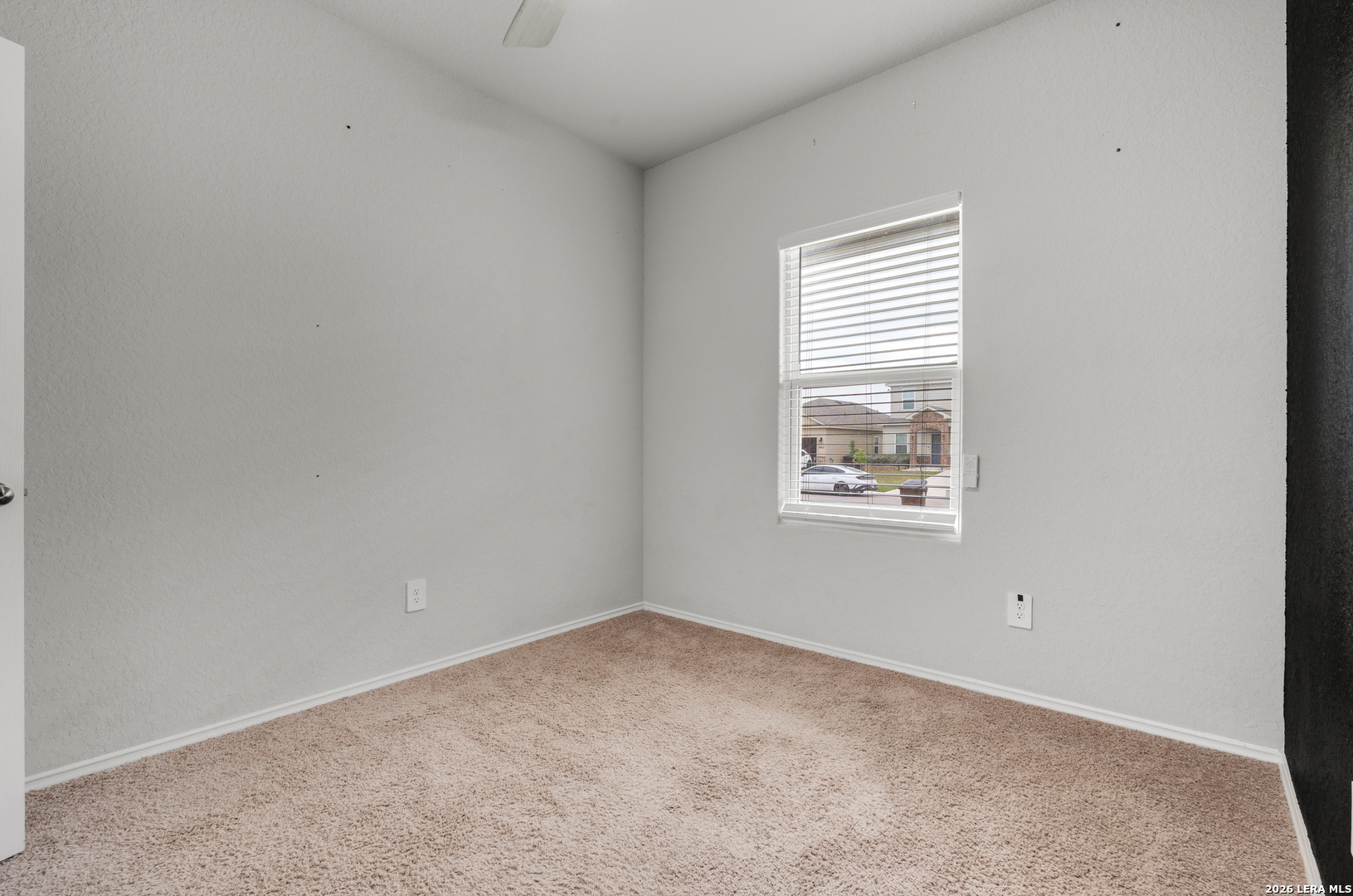 14606 Hackamore Way Elmendorf, TX 78112 - Photo 6 of 18 an empty room with a window