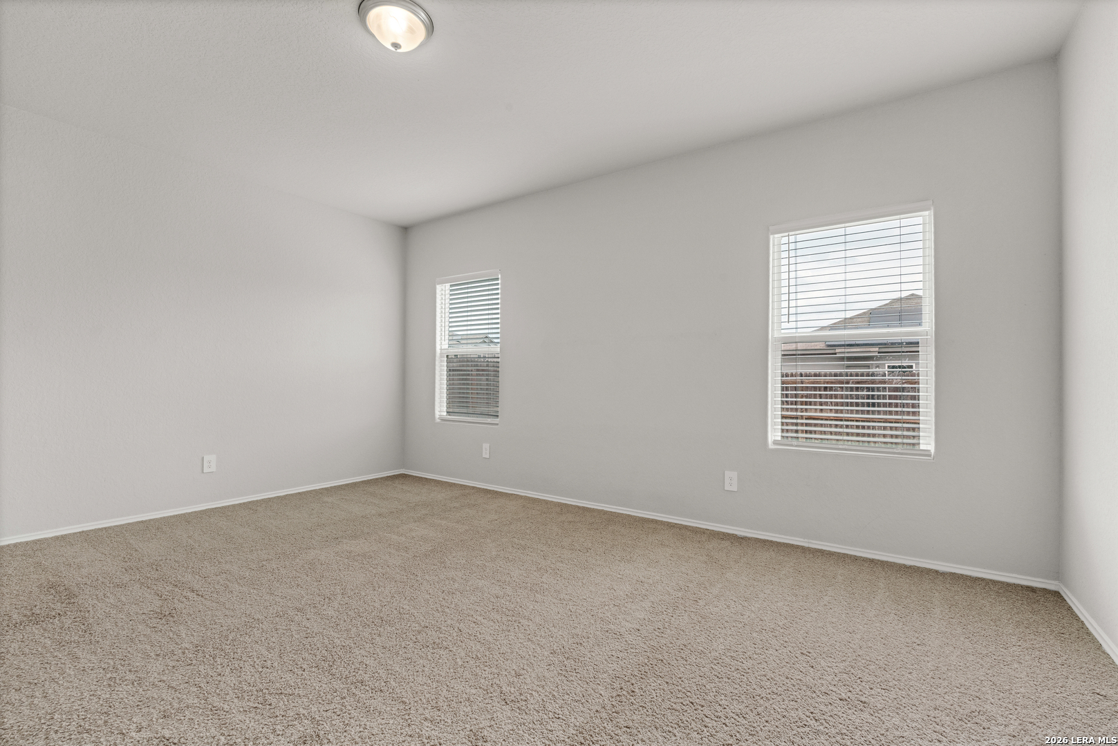 14606 Hackamore Way Elmendorf, TX 78112 - Photo 9 of 18 an empty room with windows