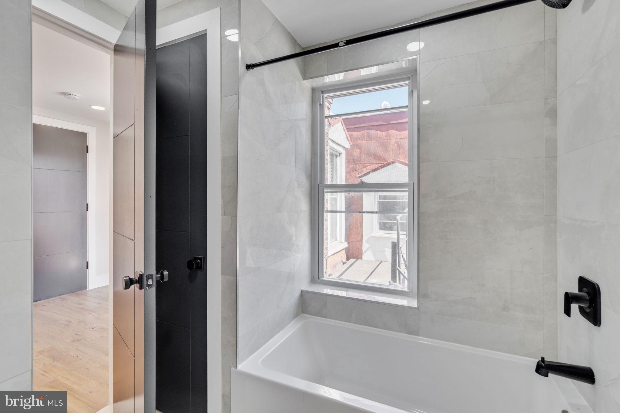 1908 Pine Street, Unit 6 Philadelphia, PA 19103 - Photo 11 of 24 a bathroom with a bathtub and a shower