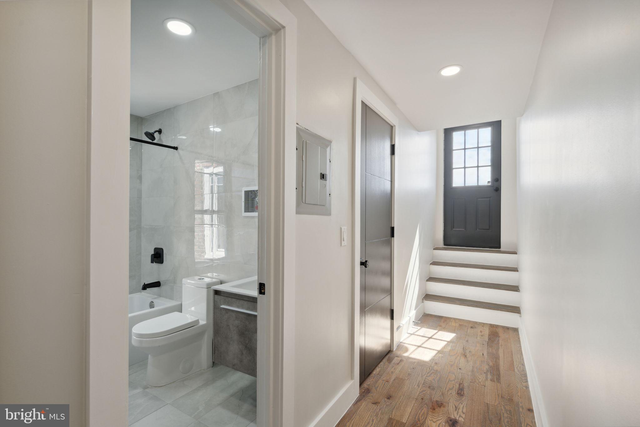 1908 Pine Street, Unit 6 Philadelphia, PA 19103 - Photo 13 of 24 a bathroom with a toilet a sink and mirror