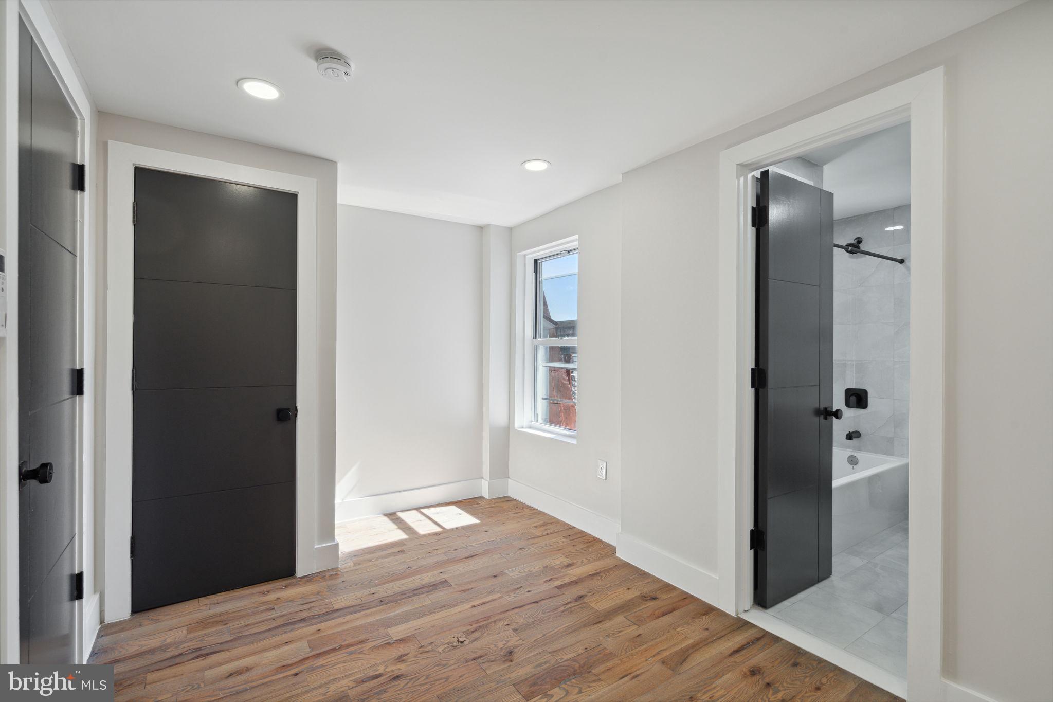 1908 Pine Street, Unit 6 Philadelphia, PA 19103 - Photo 7 of 24 a view of livingroom with wooden floor and closet
