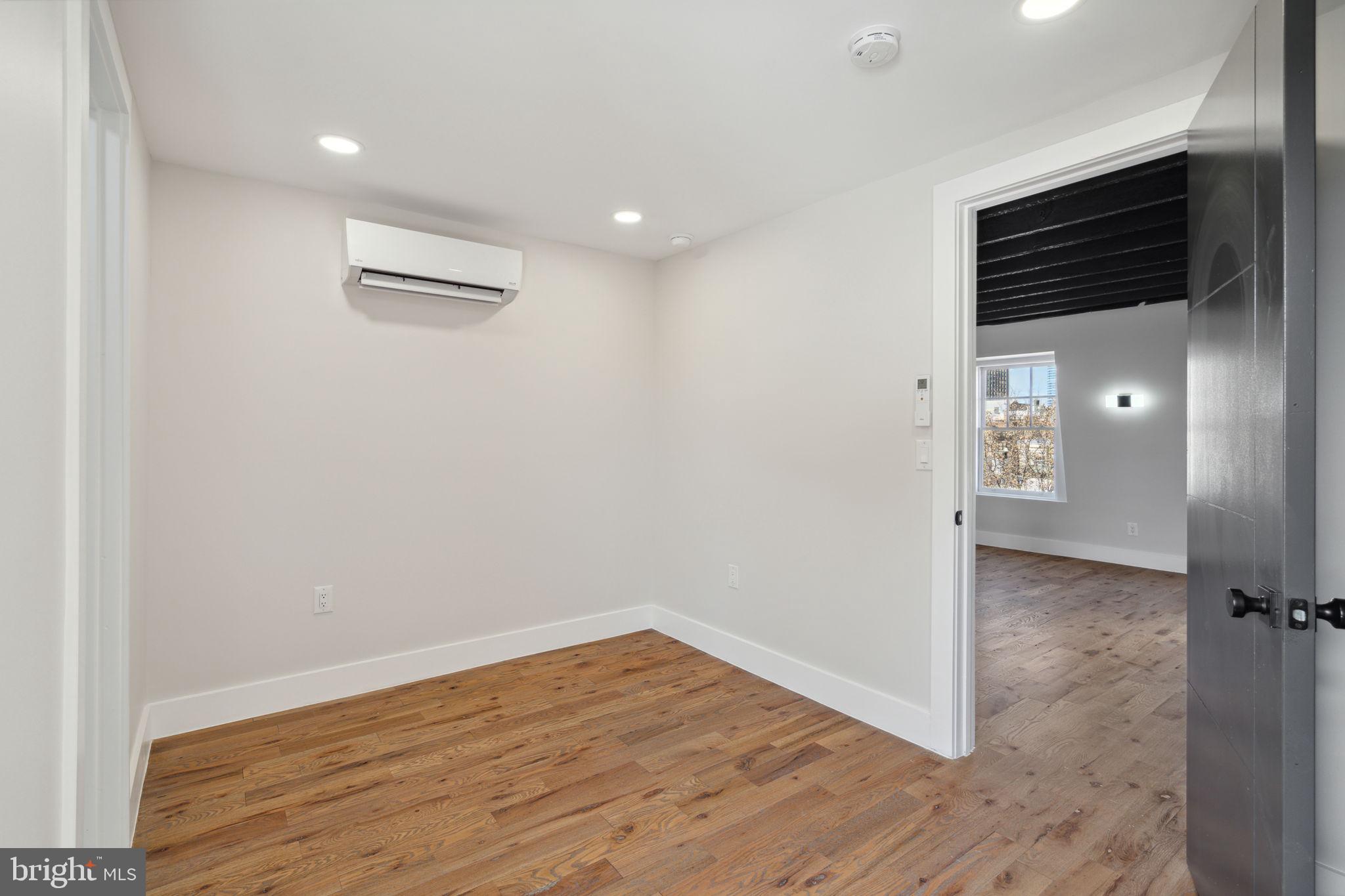 1908 Pine Street, Unit 6 Philadelphia, PA 19103 - Photo 8 of 24 an empty room with wooden floor and windows