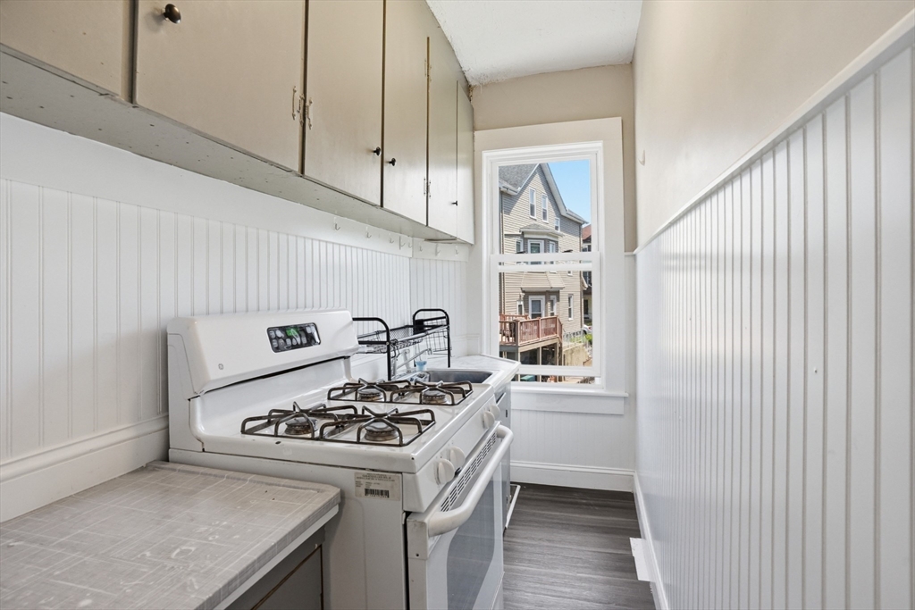 196 Irving Street Fall River, MA 02723 - Photo 6 of 34 a kitchen with stainless steel appliances granite countertop a stove and a refrigerator