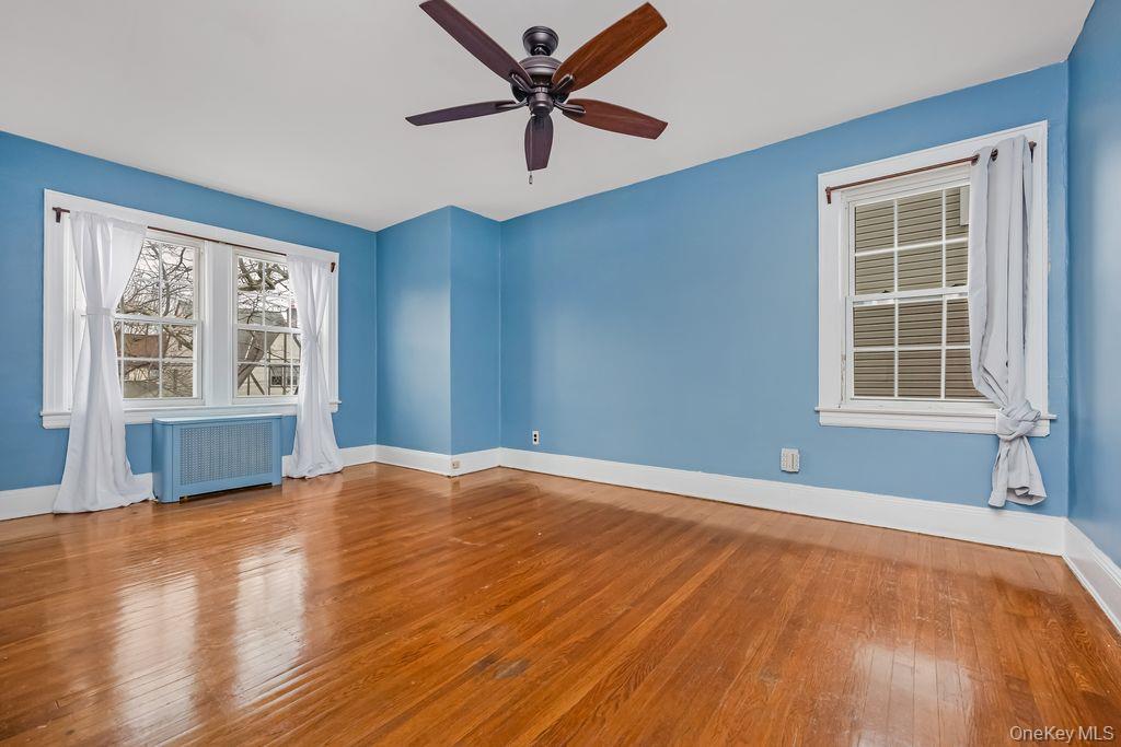 315 Marcellus Road Mineola, NY 11501 - Photo 13 of 18 a view of an empty room with a window and wooden floor