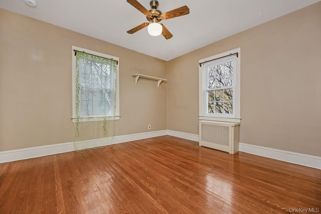 315 Marcellus Road Mineola, NY 11501 - Photo 14 of 18 a view of empty room with wooden floor and fan