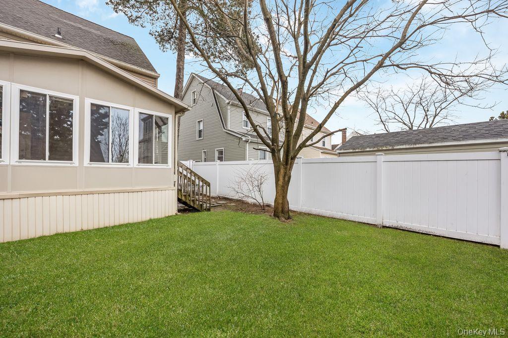 315 Marcellus Road Mineola, NY 11501 - Photo 17 of 18 a view of a house with a yard