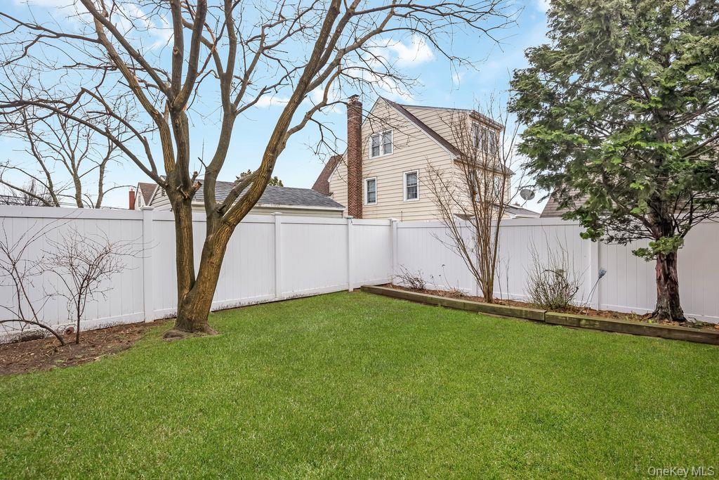 315 Marcellus Road Mineola, NY 11501 - Photo 18 of 18 a view of backyard with large trees