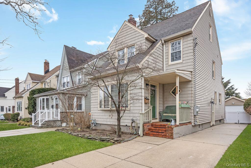 315 Marcellus Road Mineola, NY 11501 - Photo 2 of 18 a front view of a house with a garden