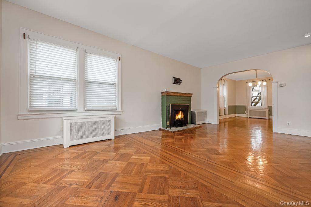 315 Marcellus Road Mineola, NY 11501 - Photo 5 of 18 a view of empty room with wooden floor and fireplace