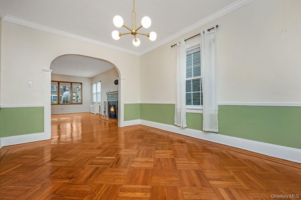 315 Marcellus Road Mineola, NY 11501 - Photo 6 of 18 a view of an empty room with a chandelier fan and windows