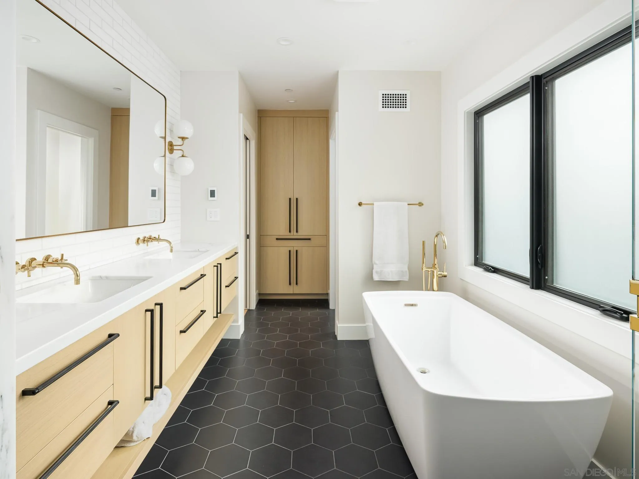631 Stratford Drive Encinitas, CA 92024 - Photo 23 of 52 a bathroom with a double vanity sink mirror and a bathtub