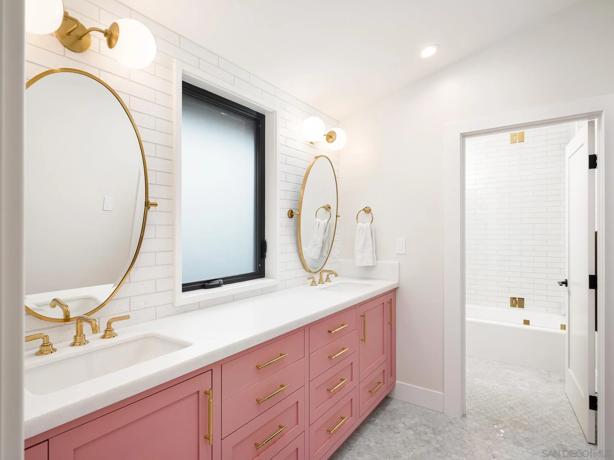 631 Stratford Drive Encinitas, CA 92024 - Photo 32 of 52 a bathroom with a double vanity sink and a mirror