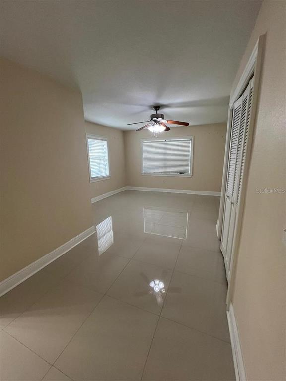 5602 Joyner Road Tampa, FL 33624 - Photo 12 of 28 a view of an empty room with a chandelier fan
