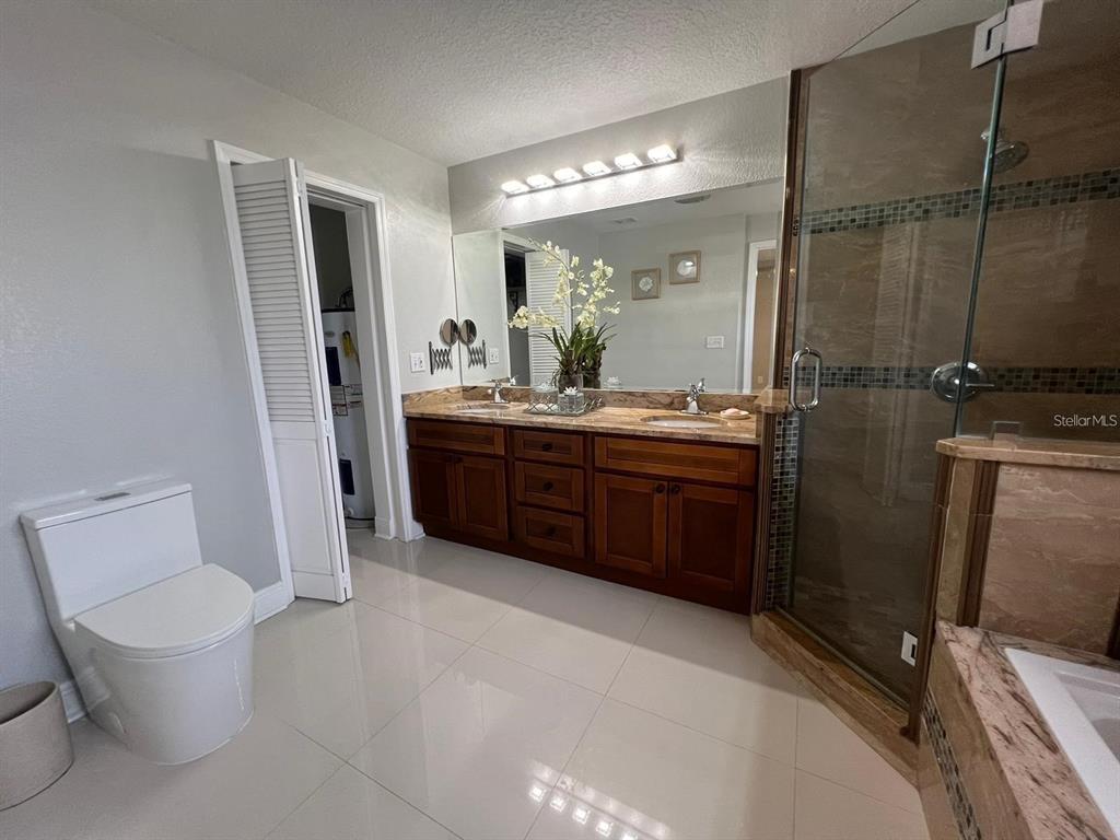 5602 Joyner Road Tampa, FL 33624 - Photo 15 of 28 a view of bathroom with a toilet sink and mirror