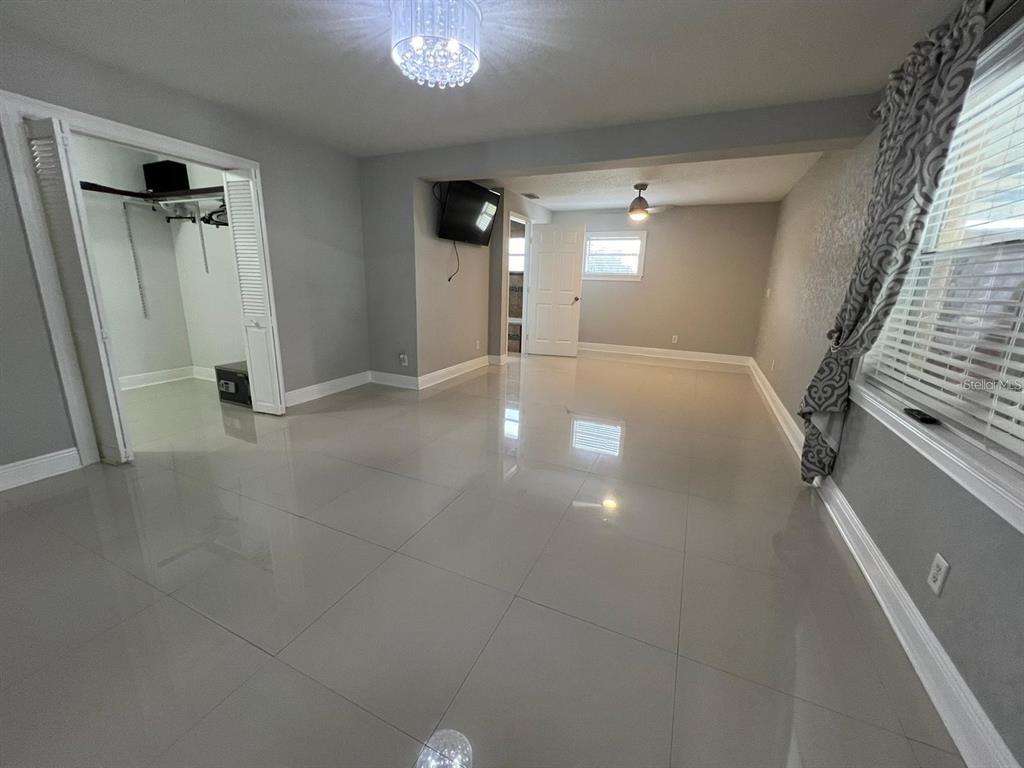 5602 Joyner Road Tampa, FL 33624 - Photo 17 of 28 en empty room with windows and stairs
