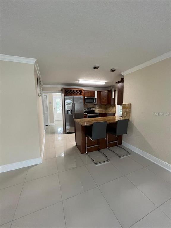 5602 Joyner Road Tampa, FL 33624 - Photo 22 of 28 a room with a table and chairs