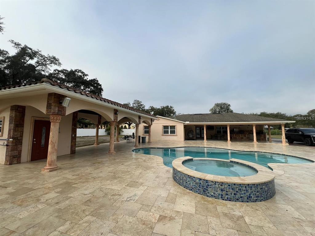 5602 Joyner Road Tampa, FL 33624 - Photo 4 of 28 a front view of house with yard outdoor seating and barbeque oven