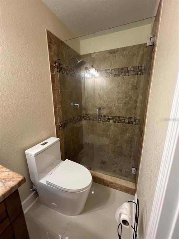 5602 Joyner Road Tampa, FL 33624 - Photo 9 of 28 a white toilet sitting next to a shower