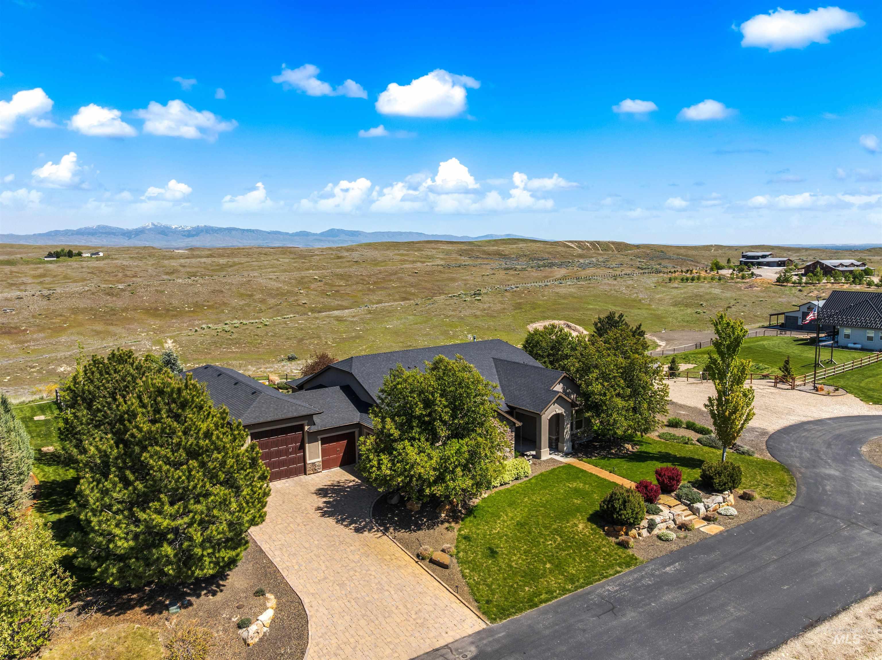 7521 North Grand Ridge Lane Eagle, ID 83616 - Photo 3 of 50 Stone and stucco exterior featuring an arched entryway