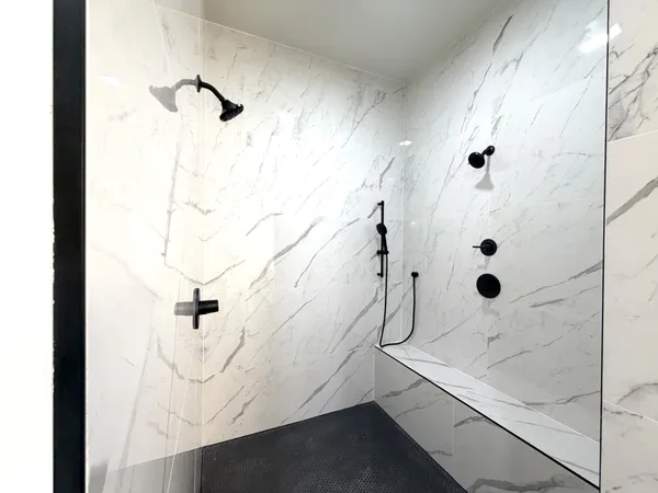 a bathroom with a glass shower door