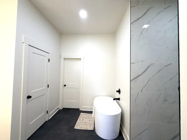 a bathroom with a bathtub and shower