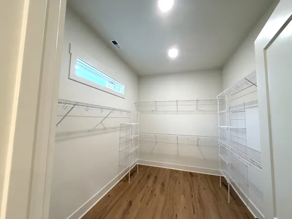 a view of a room with wooden floor and white walls